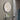 Maan Mirror in a modern bathroom, featuring a sleek round shape and elegant metal frame, enhancing contemporary decor.