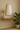 Bravo Mirror Range in gold frame with shelf, vase, and plant, showcasing modern elegance in a minimalist setting.