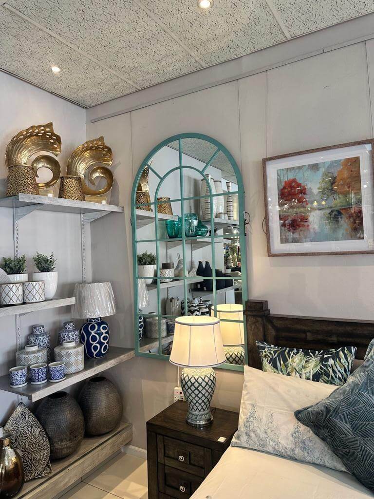 Stylish interior featuring the Arch Mirror alongside decorative items and plants for home decor.