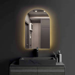 Crescent frameless LED mirror with sleek design and soft backlit feature in modern bathroom setting.