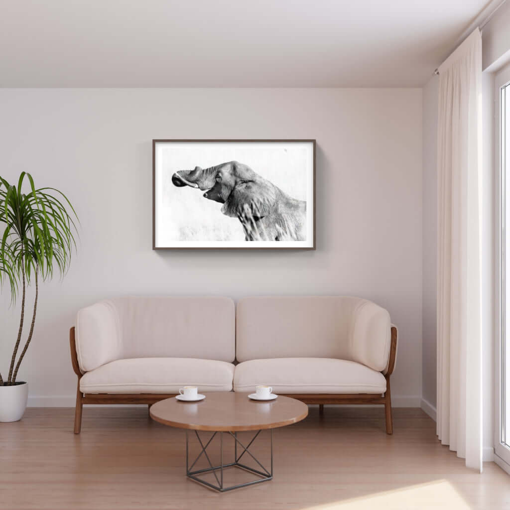Framed elephant print displayed in a modern living room, showcasing African wildlife artistry on the wall.