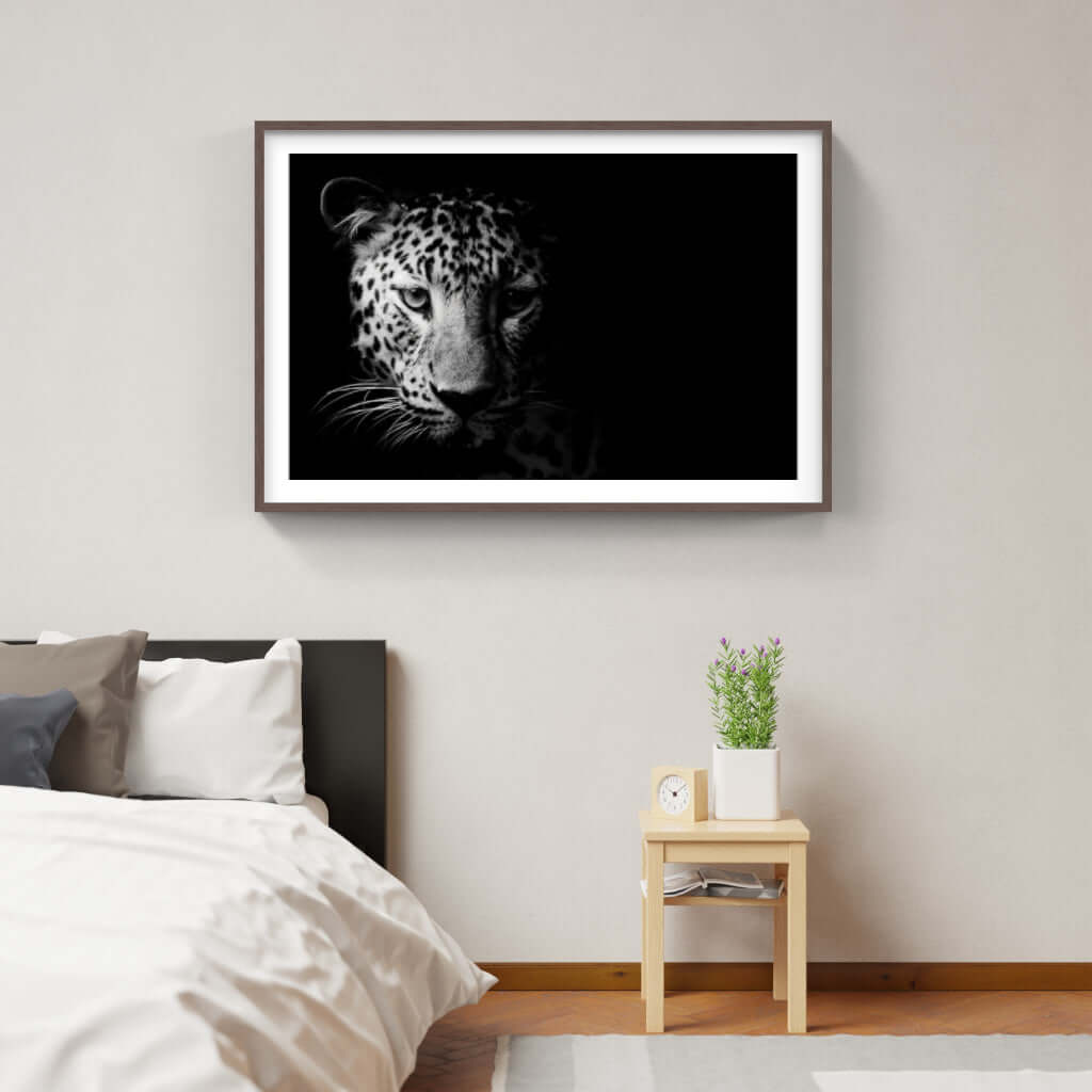 Framed artwork of a leopard's face on a wall, enhancing modern bedroom decor with African wildlife themes.