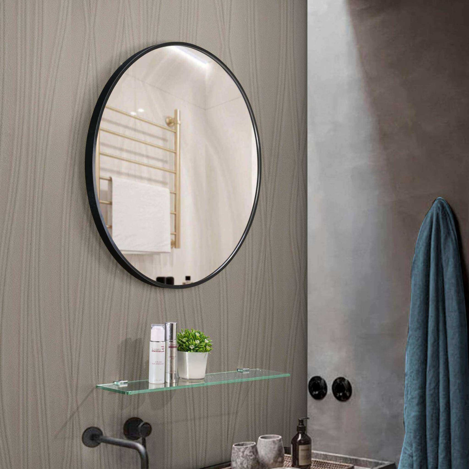 Round Aluminium Mirror Small in a modern bathroom with glass shelf and towel rack, showcasing elegant simplicity.