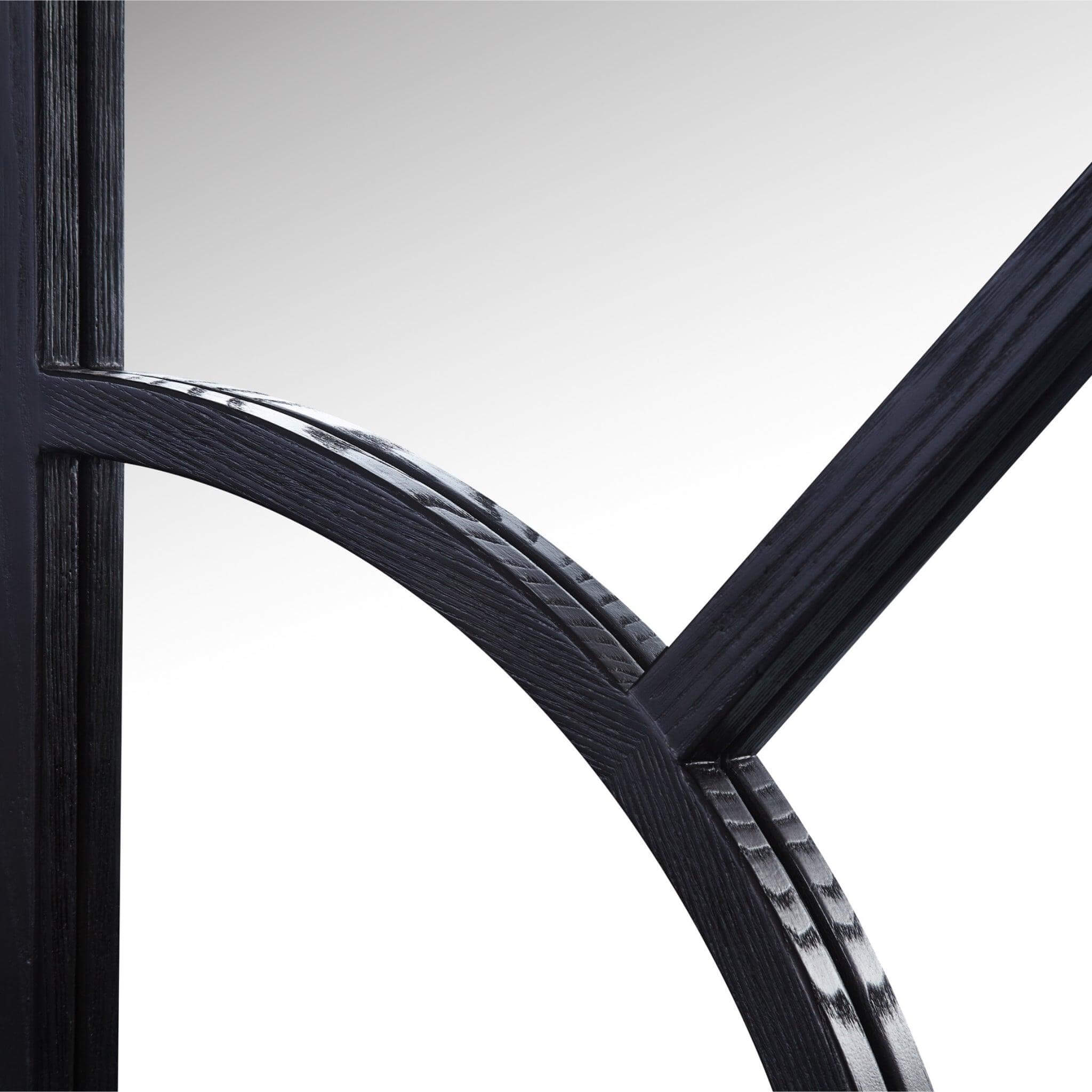 Close-up of the elegant arched design of the Arch Mirror with a wood-styled resin frame.
