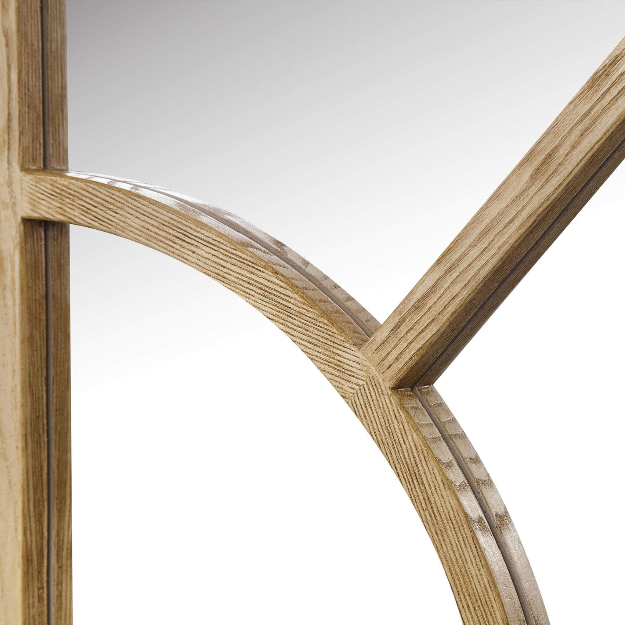 Close-up of the Arch Mirror's wood-styled resin frame featuring an elegant arched design.