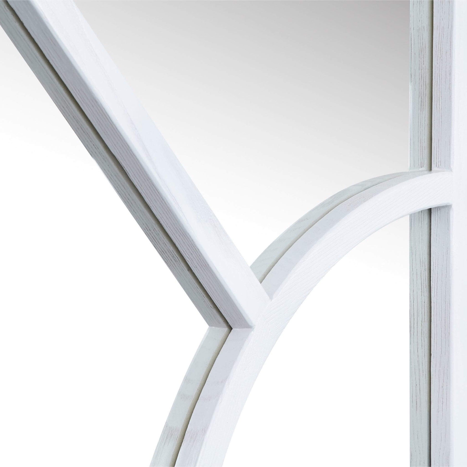Close-up of the Arch Mirror's wood-styled frame featuring an elegant arched design.