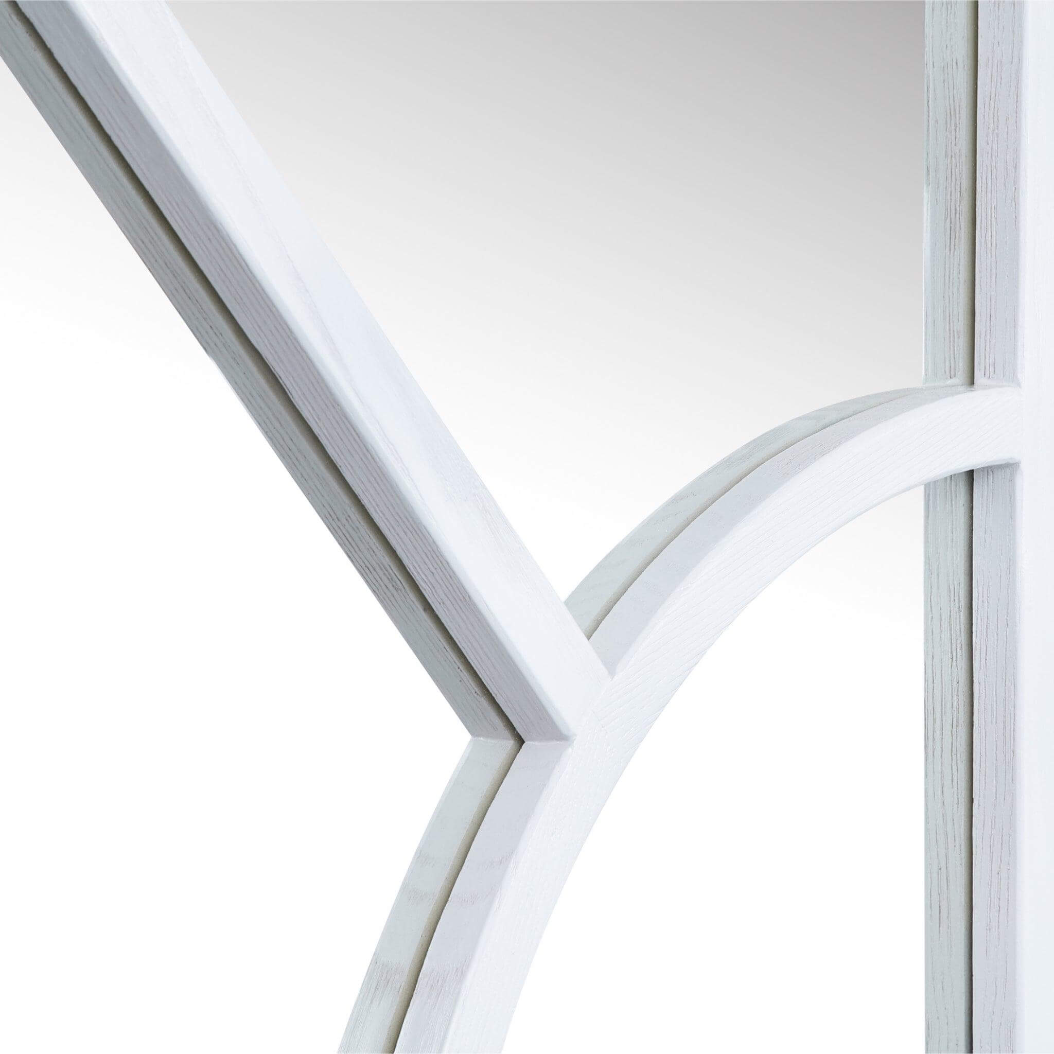Close-up of the Arch Mirror's wood-styled frame featuring an elegant arched design.