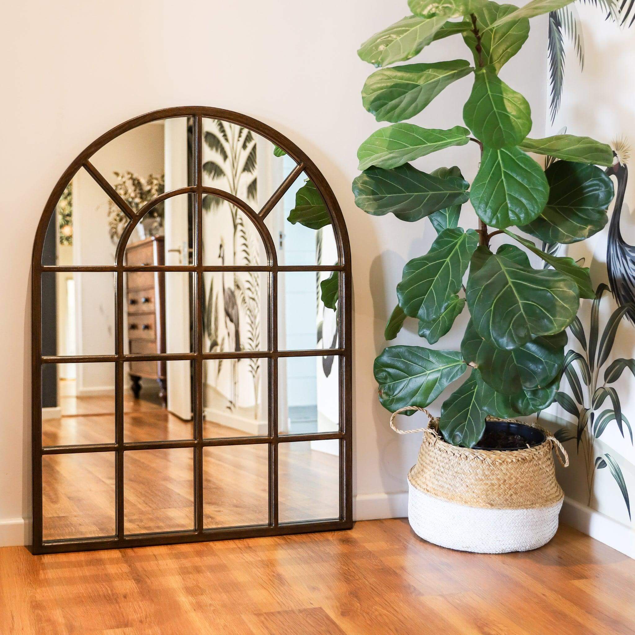Arch Mirror - Medium with arched frame and windowpane design, styled next to a fiddle leaf fig plant.