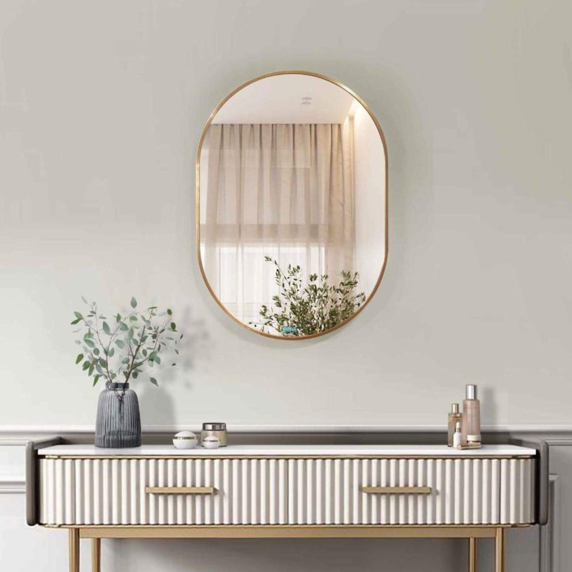 Aura Mirror - Small with sleek round frame above a stylish console table, enhancing modern home decor.