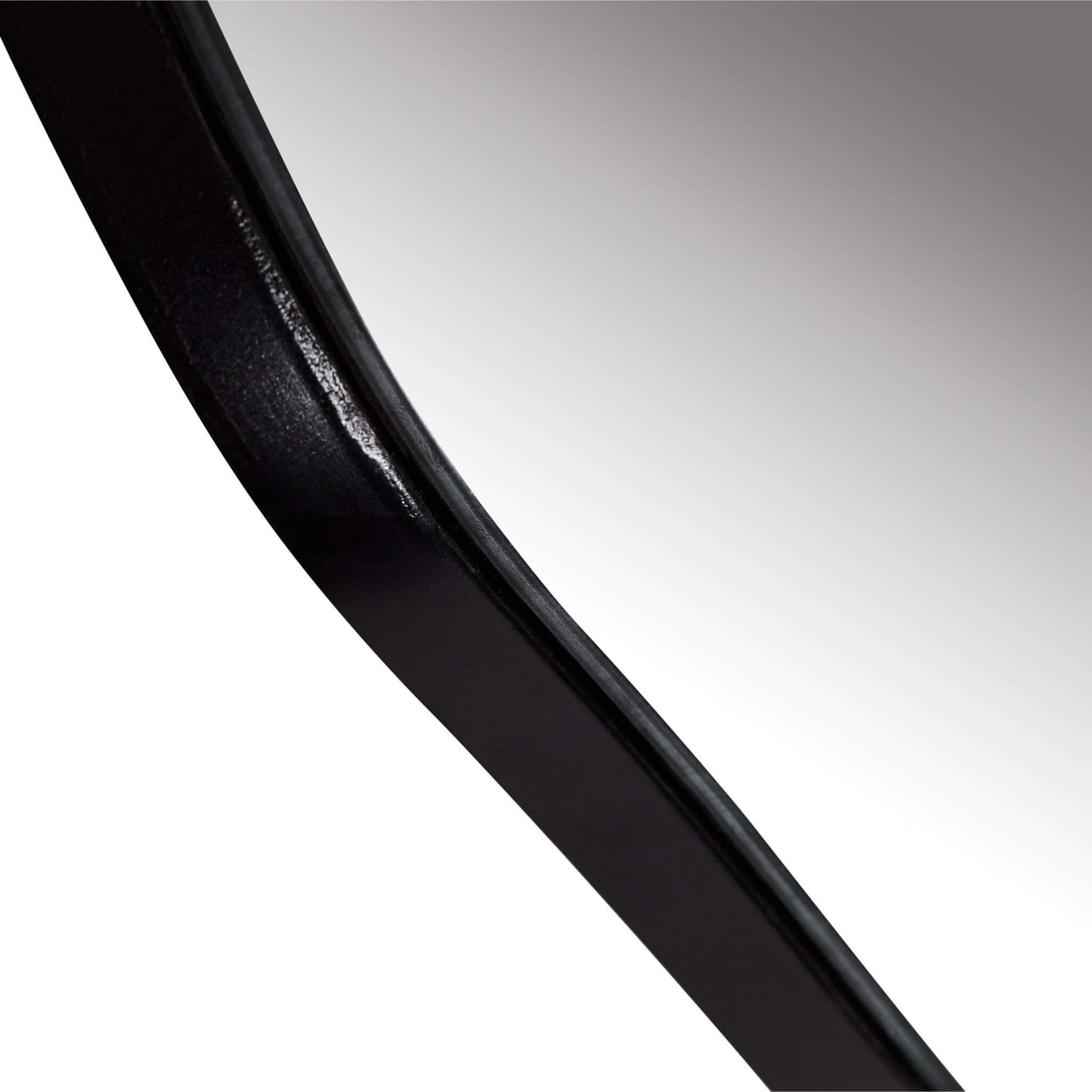 Close-up view of the sleek black edge of the Ira Irregular Mirror, showcasing its unique asymmetrical design.