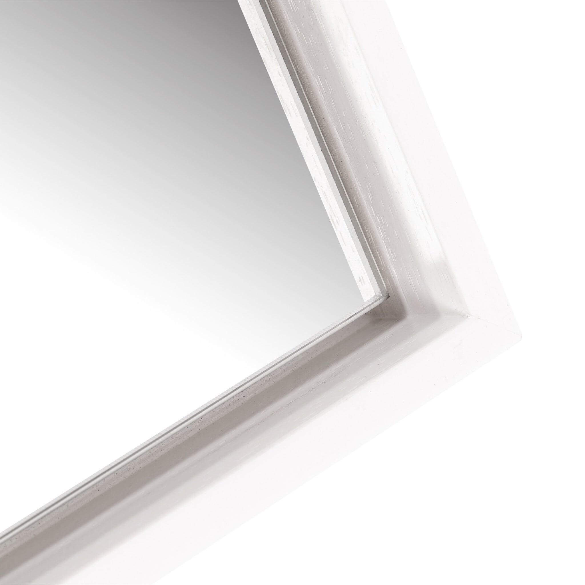 Close-up of the Lily Mirror's sleek white floating wooden frame and reflective surface.