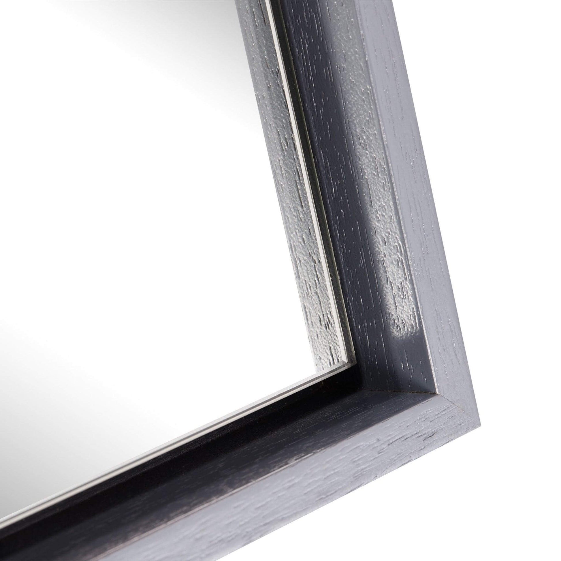 Close-up of the sleek wooden frame of the Lily Mirror, showcasing its modern design and finish.
