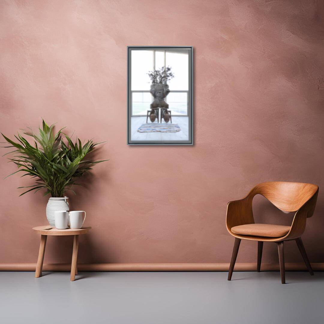 Stylish Lily Mirror displayed in a modern setting with plant and wooden chair, enhancing contemporary decor.