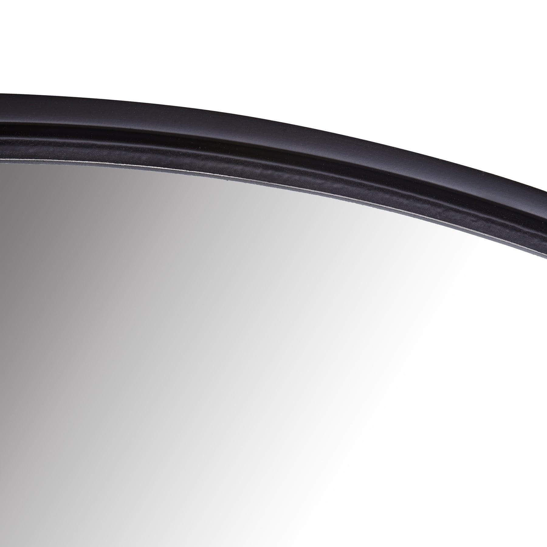 Close-up of the Lily Round Mirror showcasing its sleek resin frame and modern design.