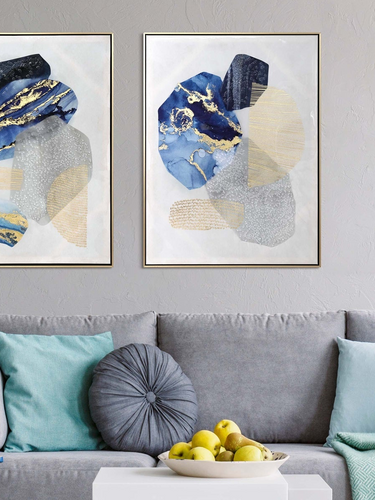 Modern living room with gray sofa, blue armchair, and abstract art on the wall.