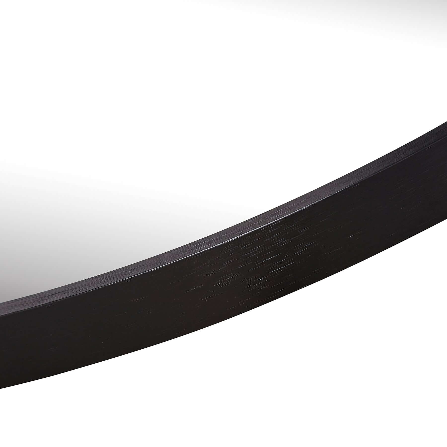 Close-up of the sleek black aluminium frame of an oval mirror, highlighting its modern minimalist design.