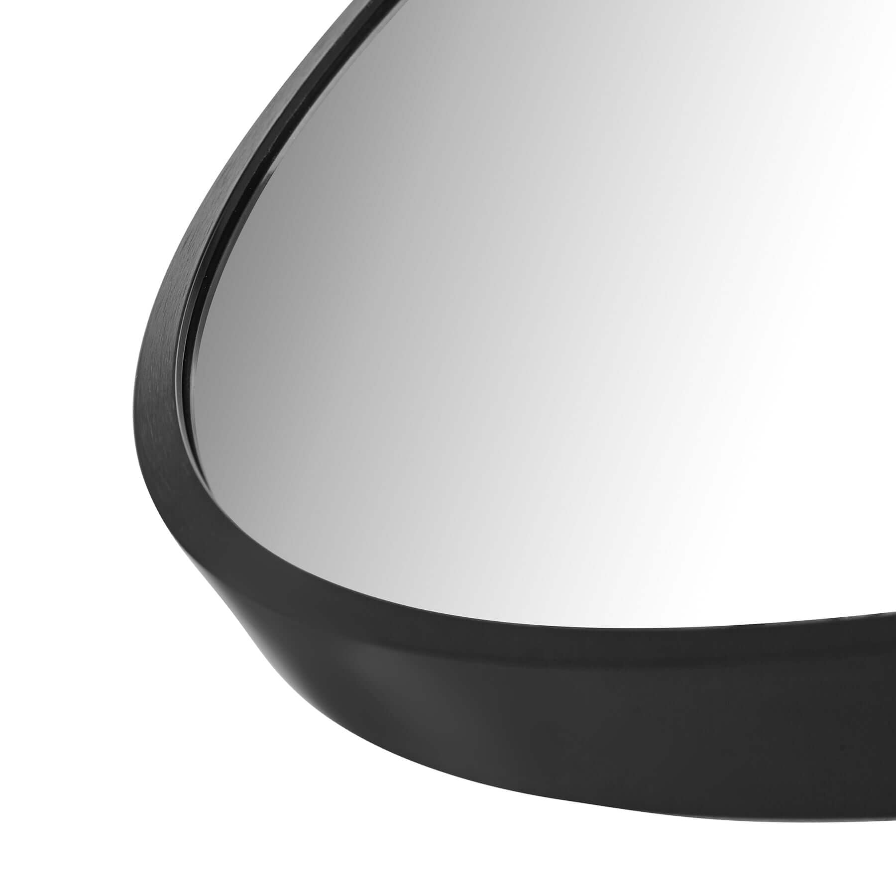 Close-up of the Round Aluminium Mirror Small showcasing its sleek black frame and reflective surface.