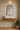 Bravo Mirror Range featuring a sleek black-framed mirror above a wooden shelf with a vase and plant.
