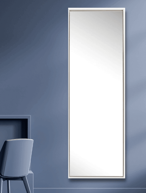 Lily Mirror - Large sleek full-length mirror with a floating wooden frame against a blue wall.