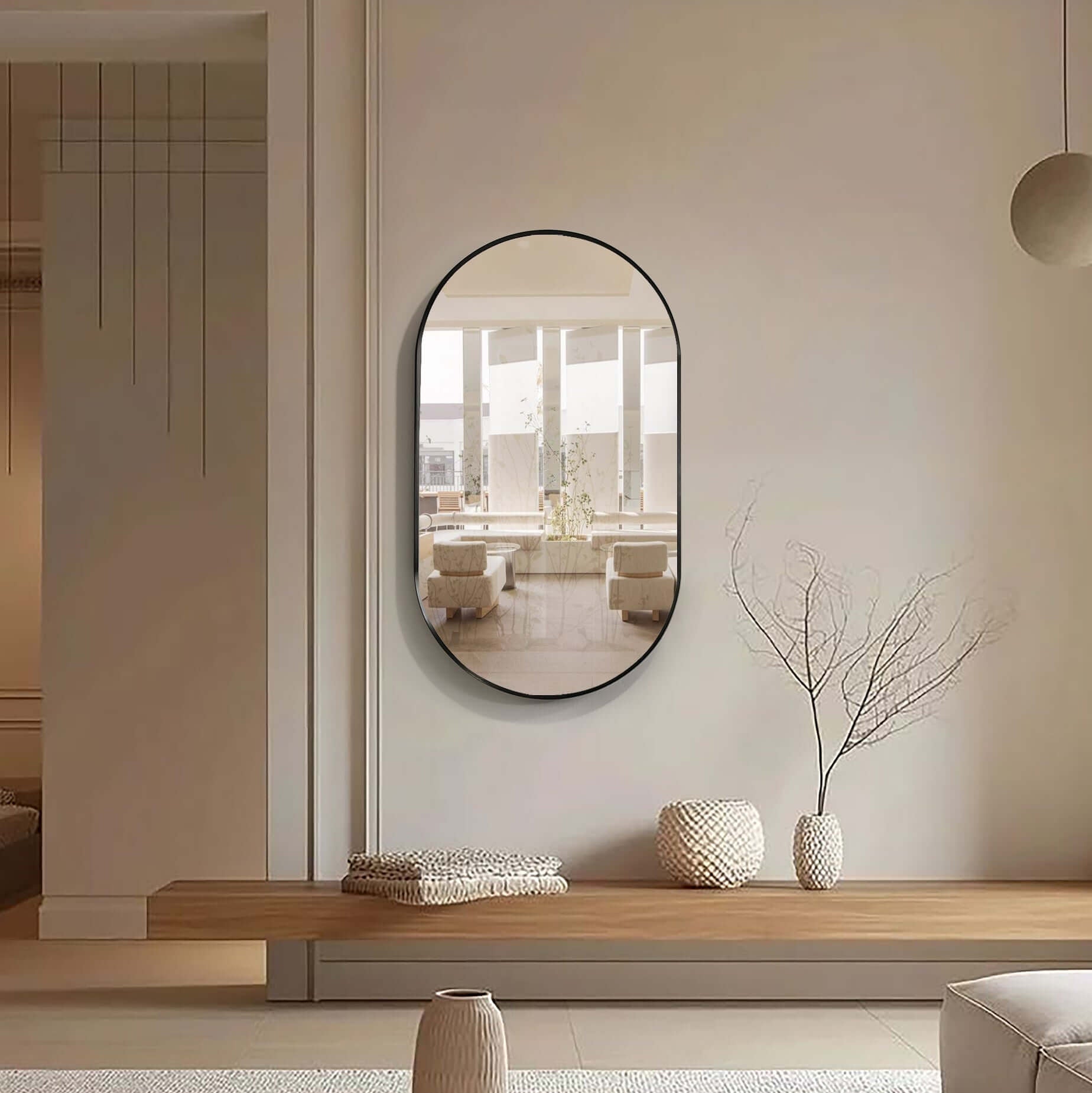 Elegant slanted aluminum framed mirror in a modern living room setting with minimalist decor.