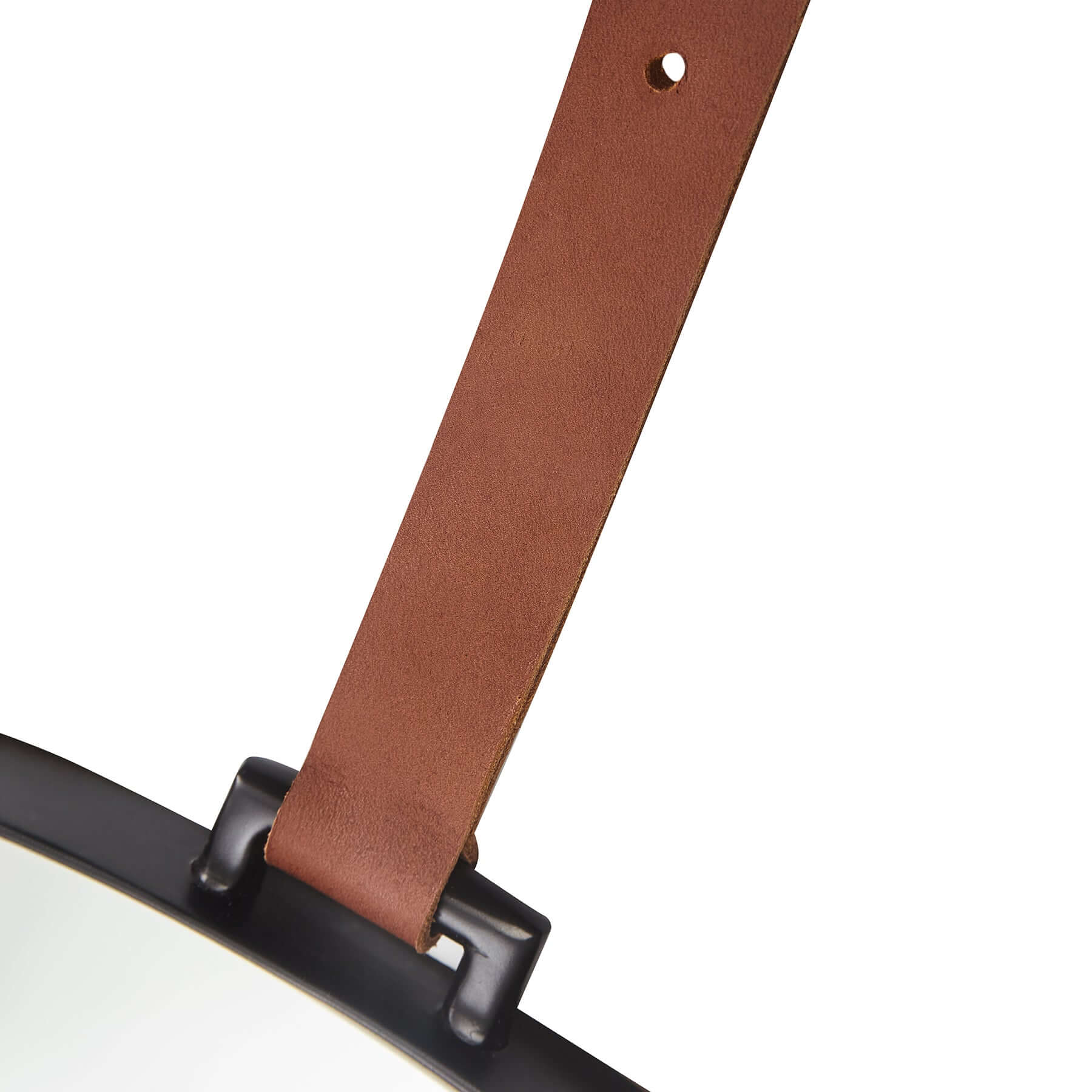 Close-up of Lexi Round Mirror's stylish leather strap for hanging, showcasing its modern elegance and design.