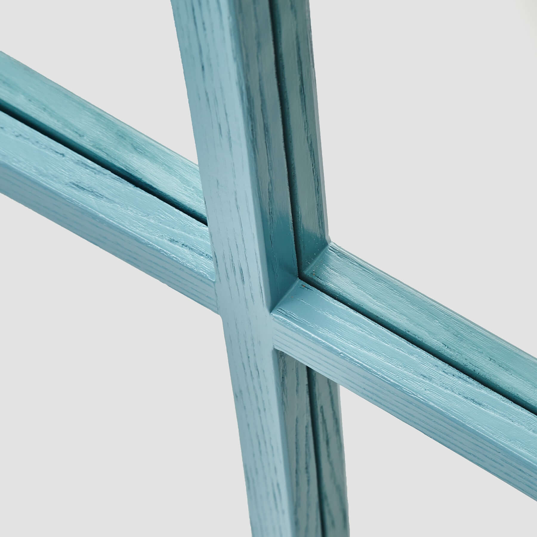 Close-up of the blue wood-styled resin frame of the Dutch Mirror, showcasing its modern design and elegant craftsmanship.