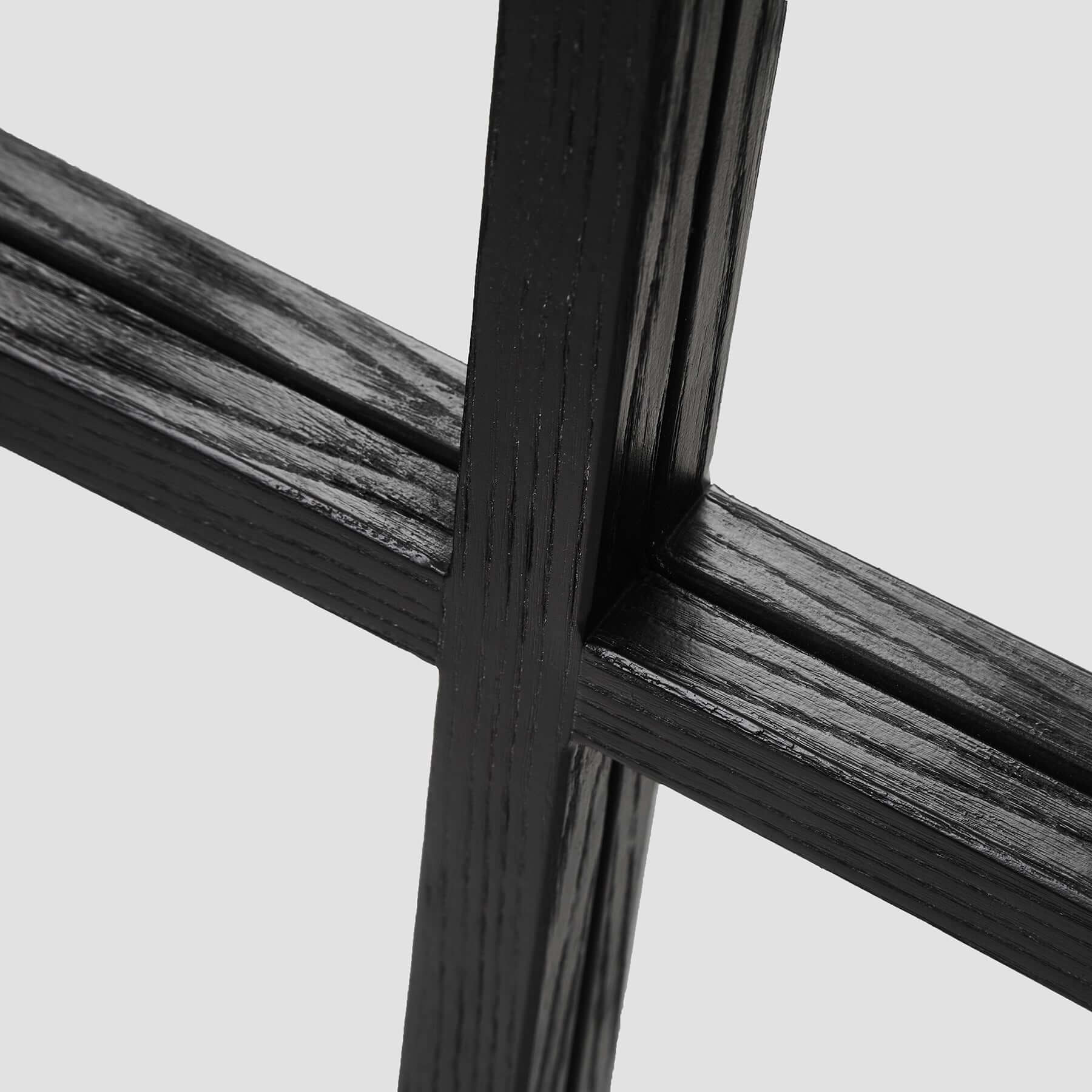 Close-up of the black wood-styled resin frame design of the Dutch Mirror, highlighting its modern aesthetics.