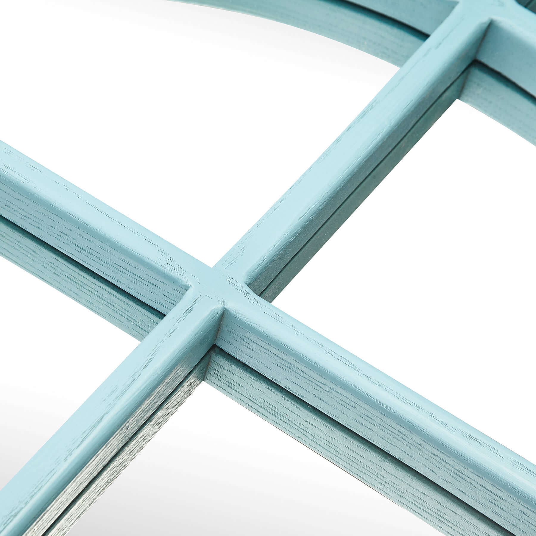 Close-up of the blue wood-styled frame of the Arch Mirror, featuring a distinctive arched top and windowpane design.