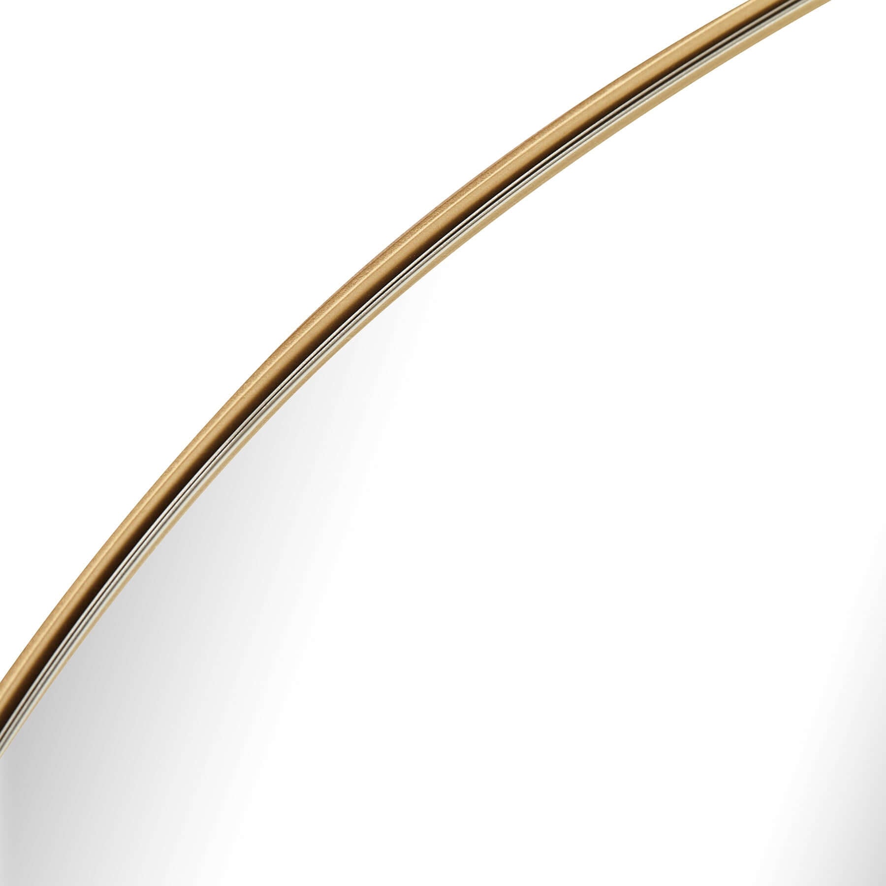 Close-up of Lexi Round Mirror's elegant gold frame reflecting light, showcasing timeless design and quality craftsmanship.