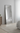Large floor mirror in a bedroom setting with a bed and dresser.
