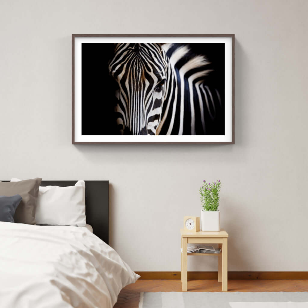 Framed wildlife print of a zebra in a modern bedroom setting, showcasing African art and decor.