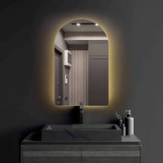 Crescent frameless LED mirror with sleek design and soft backlit feature in modern bathroom setting.